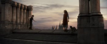 Movie still from “The Golden Compass” (2007), directed by Chris Weitz – A man and a woman standing next to each other on a bridge; Wide shot, Low angle