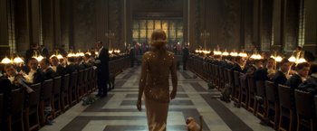 Movie still from “The Golden Compass” (2007), directed by Chris Weitz – A woman walking down the aisle of a church with a dog; Wide shot, Over the shoulder angle