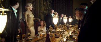 Movie still from “The Golden Compass” (2007), directed by Chris Weitz – A group of people sitting at a dinner table; Medium shot, Over the shoulder angle