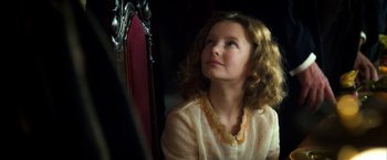 Movie still from “The Golden Compass” (2007), directed by Chris Weitz – A young girl sitting in front of a mirror looking up; Close Up shot, High angle