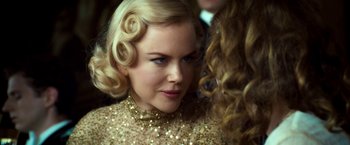 Movie still from “The Golden Compass” (2007), directed by Chris Weitz – A person wearing a gold dress; Close Up shot, Over the shoulder angle