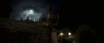 Movie still from “The Golden Compass” (2007), directed by Chris Weitz – A night time view of a castle with a full moon in the background; Extreme Wide shot, Low angle