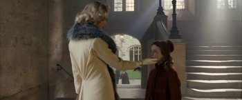 Movie still from “The Golden Compass” (2007), directed by Chris Weitz – A woman and a child are standing in a building; Medium shot, Over the shoulder angle