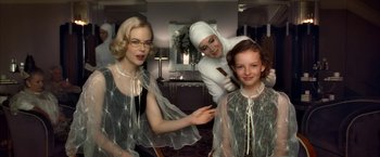 Movie still from “The Golden Compass” (2007), directed by Chris Weitz – Two women and a girl are dressed up for halloween; Medium shot, Over the shoulder angle