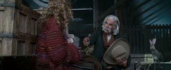 Movie still from “The Golden Compass” (2007), directed by Chris Weitz – An old man sitting next to a woman in a chair; Medium shot, Over the shoulder angle