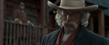 Movie still from “The Golden Compass” (2007), directed by Chris Weitz – An old man with a long white beard wearing a cowboy hat; Close Up shot, Low angle