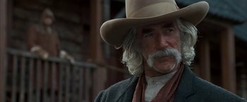 Movie still from “The Golden Compass” (2007), directed by Chris Weitz – An older man with a long white beard wearing a cowboy hat; Close Up shot, Over the shoulder angle