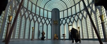 Movie still from “The Golden Compass” (2007), directed by Chris Weitz – Two people are standing in an ornate room; Extreme Wide shot, Low angle