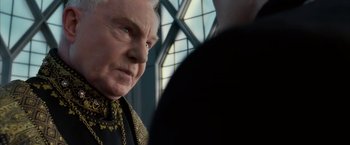 Movie still from “The Golden Compass” (2007), directed by Chris Weitz – An older man in a black shirt is looking at a man in a black shirt; Close Up shot, Over the shoulder angle