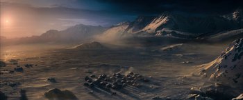 Movie still from “The Golden Compass” (2007), directed by Chris Weitz – An aerial view of a desert with mountains in the background; Extreme Wide shot, High angle