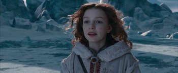 Movie still from “The Golden Compass” (2007), directed by Chris Weitz – A young girl with long red hair wearing a white jacket; Close Up shot, High angle