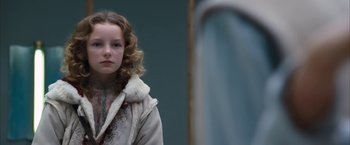 Movie still from “The Golden Compass” (2007), directed by Chris Weitz – A young girl looking at herself in a mirror; Close Up shot, Over the shoulder angle