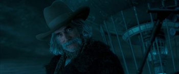 Movie still from “The Golden Compass” (2007), directed by Chris Weitz – An old man with a gray beard wearing a cowboy hat; Close Up shot, Low angle