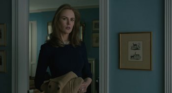 Movie still from “The Goldfinch” (2019), directed by John Crowley – A woman standing in front of a mirror in a room; Medium shot, Low angle