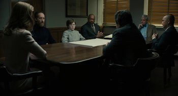 Movie still from “The Goldfinch” (2019), directed by John Crowley – A group of people sitting around a table talking; Wide shot, Over the shoulder angle