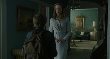 Movie still from “The Goldfinch” (2019), directed by John Crowley – A woman in a white dress talking to a young boy; Medium shot, Over the shoulder angle