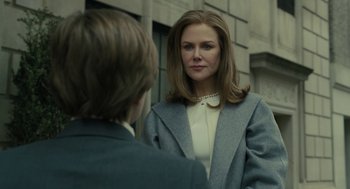 Movie still from “The Goldfinch” (2019), directed by John Crowley – A woman wearing a gray jacket and a white blouse; Close Up shot, Over the shoulder angle