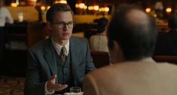 Movie still from “The Goldfinch” (2019), directed by John Crowley – A man in a suit talking to a man in a suit; Medium shot, Over the shoulder angle