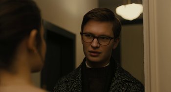 Movie still from “The Goldfinch” (2019), directed by John Crowley – A young man wearing glasses looking at the camera; Close Up shot, Over the shoulder angle