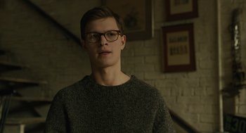 Movie still from “The Goldfinch” (2019), directed by John Crowley – A young man wearing glasses and a sweater; Close Up shot, Over the shoulder angle