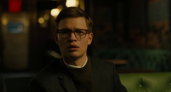 Movie still from “The Goldfinch” (2019), directed by John Crowley – A young man wearing a suit and glasses; Close Up shot, Low angle