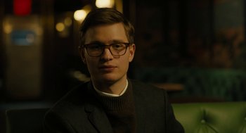 Movie still from “The Goldfinch” (2019), directed by John Crowley – A young man wearing a suit and glasses; Close Up shot, Low angle