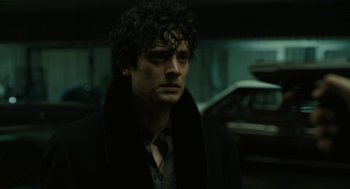 Movie still from “The Goldfinch” (2019), directed by John Crowley – A person wearing a coat; Close Up shot, Low angle