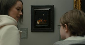 Movie still from “The Goldfinch” (2019), directed by John Crowley – Two people are looking at a painting on the wall; Extreme Close Up shot, Over the shoulder angle