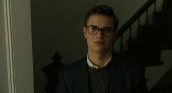 Movie still from “The Goldfinch” (2019), directed by John Crowley – A young man wearing glasses and a jacket; Close Up shot, Low angle