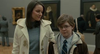Movie still from “The Goldfinch” (2019), directed by John Crowley – A woman and a young boy standing next to each other; Medium shot, Over the shoulder angle