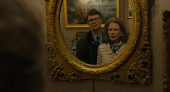 Movie still from “The Goldfinch” (2019), directed by John Crowley – A man and a woman standing in front of a mirror; Close Up shot, Over the shoulder angle