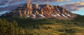 Movie still from “The Good Dinosaur” (2015), directed by Peter Sohn – A view of a mountain range with snow on it's side; Extreme Wide shot, High angle