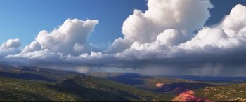 Movie still from “The Good Dinosaur” (2015), directed by Peter Sohn – A view of a mountain range with a cloudy sky above it; Extreme Wide shot, Low angle