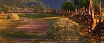 Movie still from “The Good Dinosaur” (2015), directed by Peter Sohn – A field that has a bunch of hay in it; Extreme Wide shot, High angle