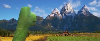 Movie still from “The Good Dinosaur” (2015), directed by Peter Sohn – A large green creature in the middle of an open field; Extreme Wide shot, Over the shoulder angle