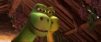 Movie still from “The Good Dinosaur” (2015), directed by Peter Sohn – A couple of dinosaurs are standing next to each other; Close Up shot, High angle