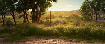 Movie still from “The Good Dinosaur” (2015), directed by Peter Sohn – An image of an animal in a field with trees in the background; Extreme Wide shot, Low angle