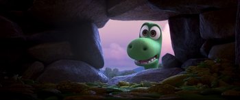 Movie still from “The Good Dinosaur” (2015), directed by Peter Sohn – A green dinosaur is looking out of a cave; Medium shot, High angle