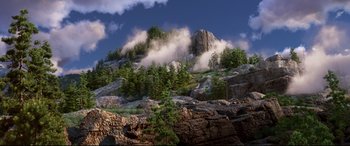 Movie still from “The Good Dinosaur” (2015), directed by Peter Sohn – An image of a mountain with trees in the background; Extreme Wide shot, High angle