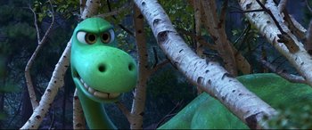 Movie still from “The Good Dinosaur” (2015), directed by Peter Sohn – The head of a green dinosaur; Close Up shot, High angle