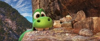 Movie still from “The Good Dinosaur” (2015), directed by Peter Sohn – The head of a green dinosaur; Extreme Wide shot, High angle