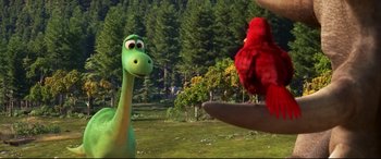 Movie still from “The Good Dinosaur” (2015), directed by Peter Sohn – A red bird is standing next to a green dinosaur; Medium shot, Over the shoulder angle