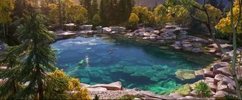 Movie still from “The Good Dinosaur” (2015), directed by Peter Sohn – A person swimming in a lake surrounded by trees; Extreme Wide shot, High angle