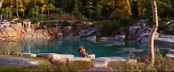 Movie still from “The Good Dinosaur” (2015), directed by Peter Sohn – A dog sitting on the edge of a pool of water; Extreme Wide shot, High angle