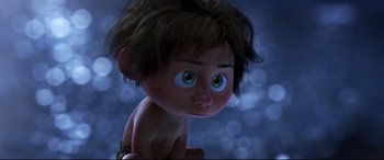 Movie still from “The Good Dinosaur” (2015), directed by Peter Sohn – A cartoon character with green eyes; Medium shot, High angle