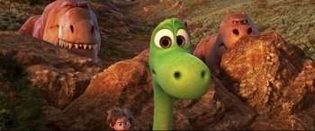 Movie still from “The Good Dinosaur” (2015), directed by Peter Sohn – A group of people standing next to each other in a field; Wide shot, High angle