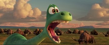Movie still from “The Good Dinosaur” (2015), directed by Peter Sohn – A green dinosaur with its mouth wide open in a grassy field; Close Up shot, High angle