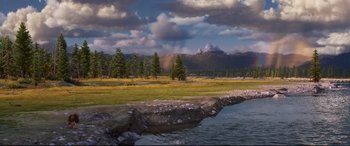 Movie still from “The Good Dinosaur” (2015), directed by Peter Sohn – A view of a river and some trees and mountains in the background; Extreme Wide shot, High angle