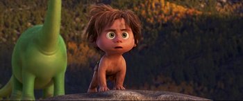 Movie still from “The Good Dinosaur” (2015), directed by Peter Sohn – A little boy that is standing on a rock; Medium shot, Low angle