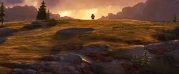 Movie still from “The Good Dinosaur” (2015), directed by Peter Sohn – An image of a person standing in a field at sunset; Extreme Wide shot, High angle